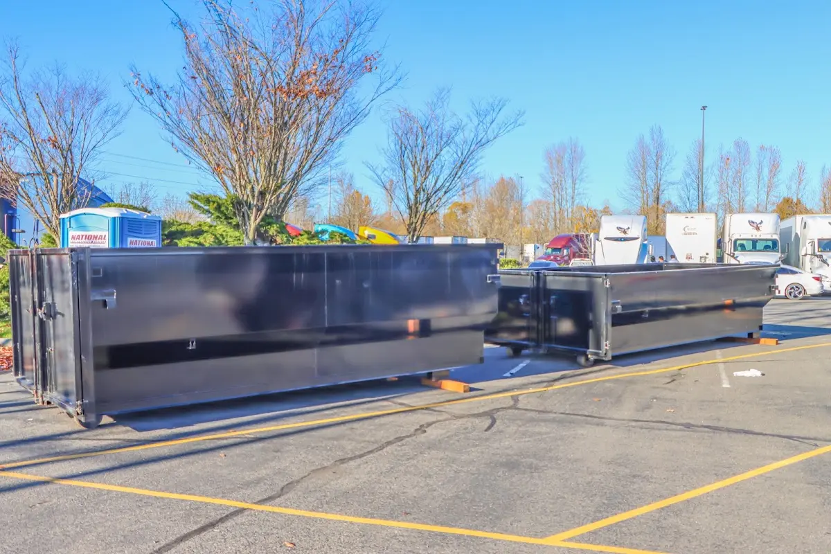 Professional dumpster rental service with roll-off container on residential driveway in Apollo Beach